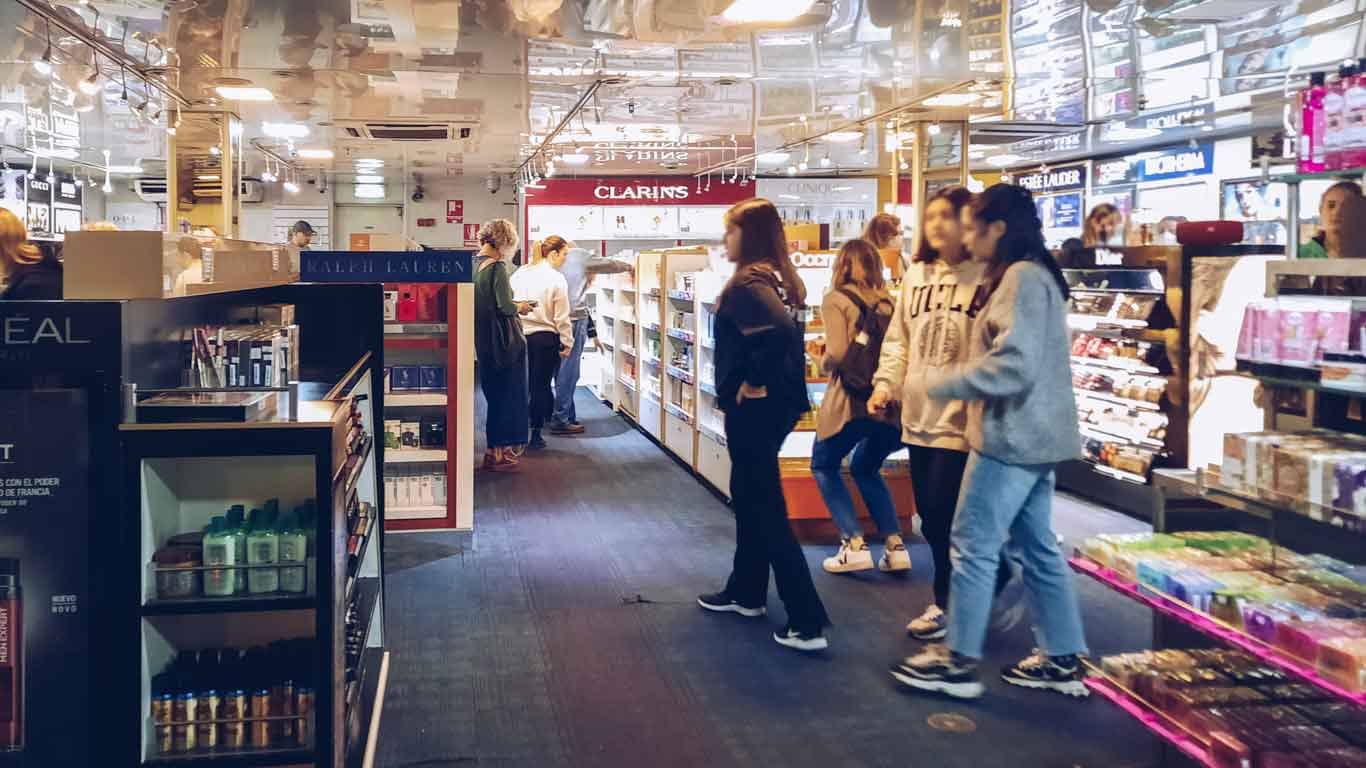 People strolling through the perfume and makeup shelves at the Duty Free on the ferry to Colonia del Sacramento.