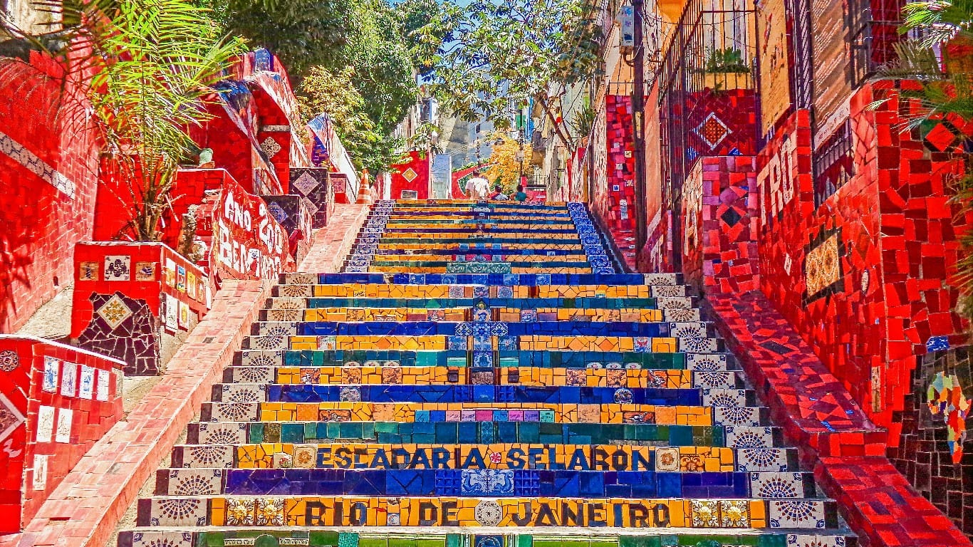 The Escadaria Selarón, a vibrant staircase and tribute to the Brazilian people by Chilean-born artist Jorge Selarón, dazzles with its colorful mosaic tiles and artistic designs, becoming an iconic landmark in the bohemian neighborhood of Santa Teresa in Rio de Janeiro.