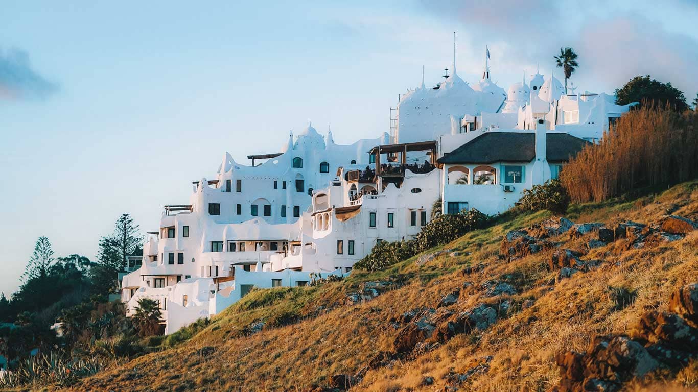 Casapueblo, the iconic whitewashed building and art gallery, basks in the warm golden light of the late afternoon sun, perched on the rugged hillside of Punta Ballena, making it an excellent choice for where to stay in Punta del Este.